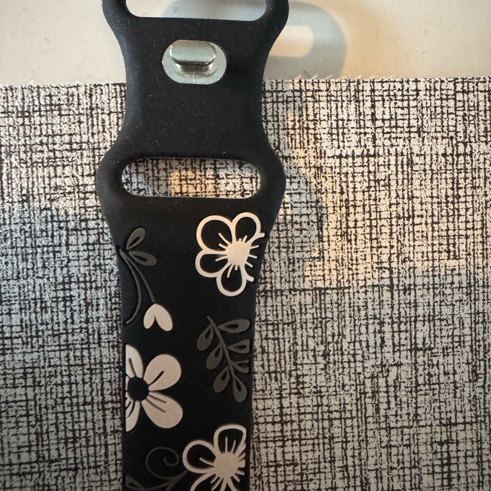 Apple Watch Series 6 band is 40mm with a White Floral Design band  and charger.